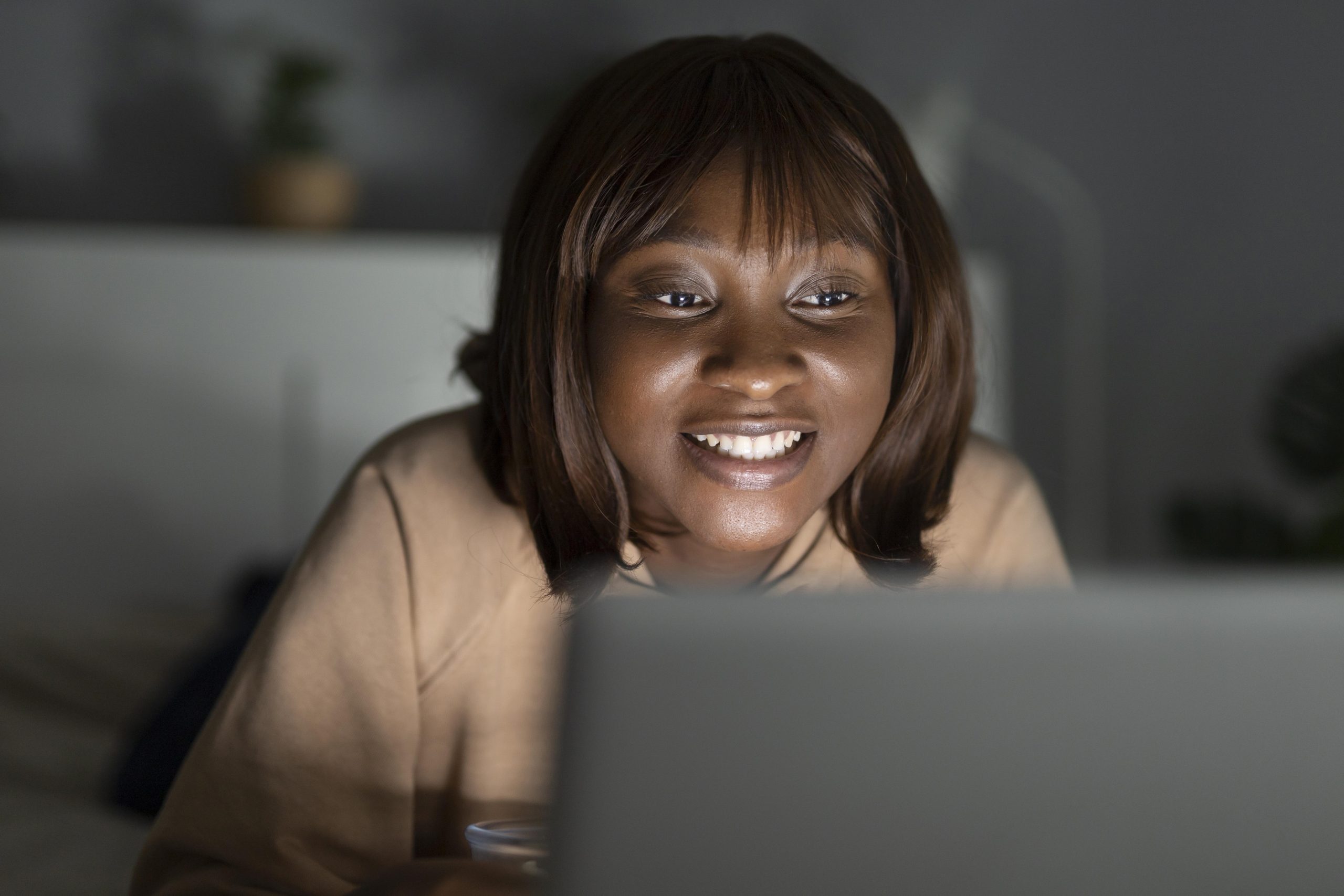 smiley african american woman watching streaming service home scaled